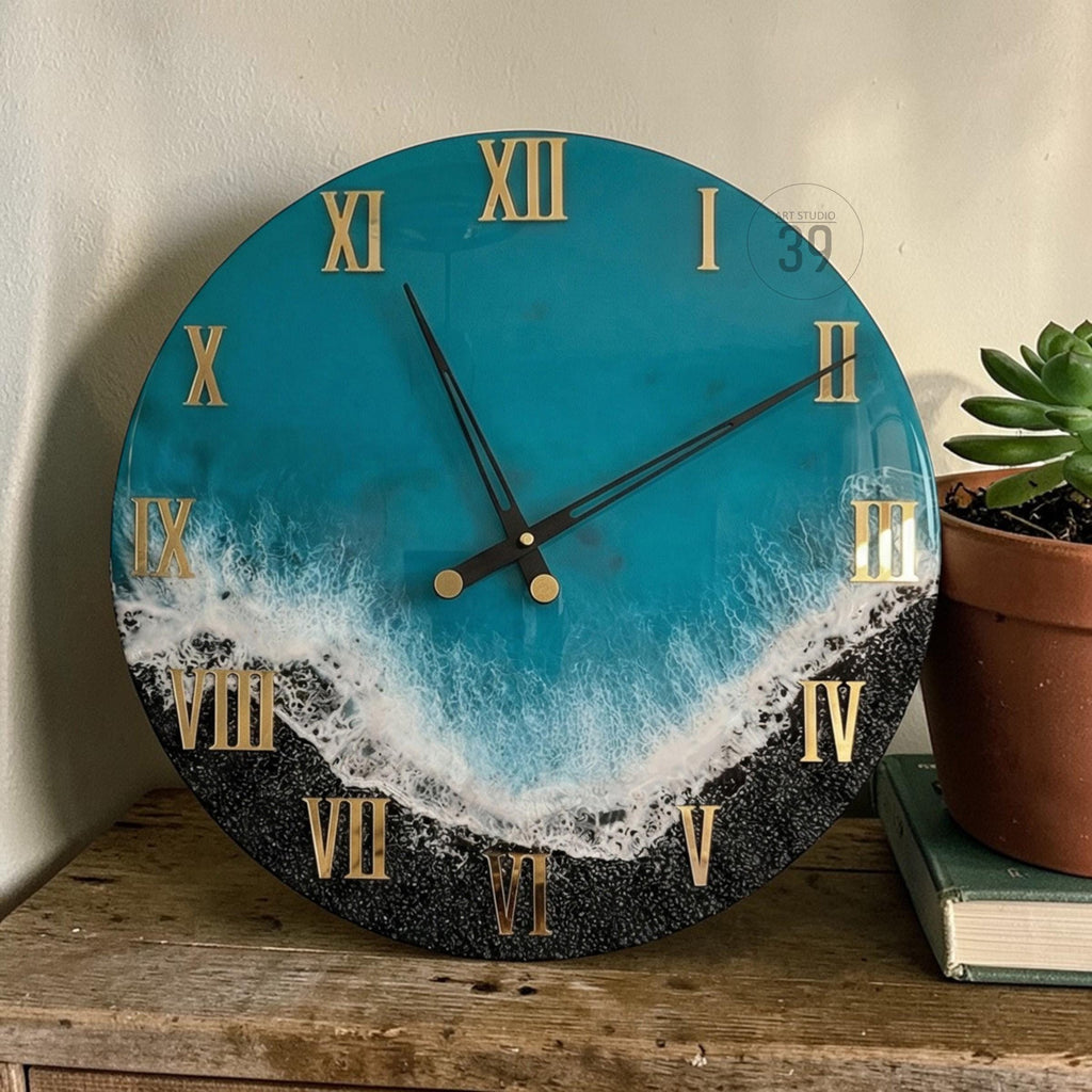 Round wall clock with a teal and black ocean-themed design. The clock face features gold Roman numerals and black clock hands. The design includes a wave pattern and a black, textured base.