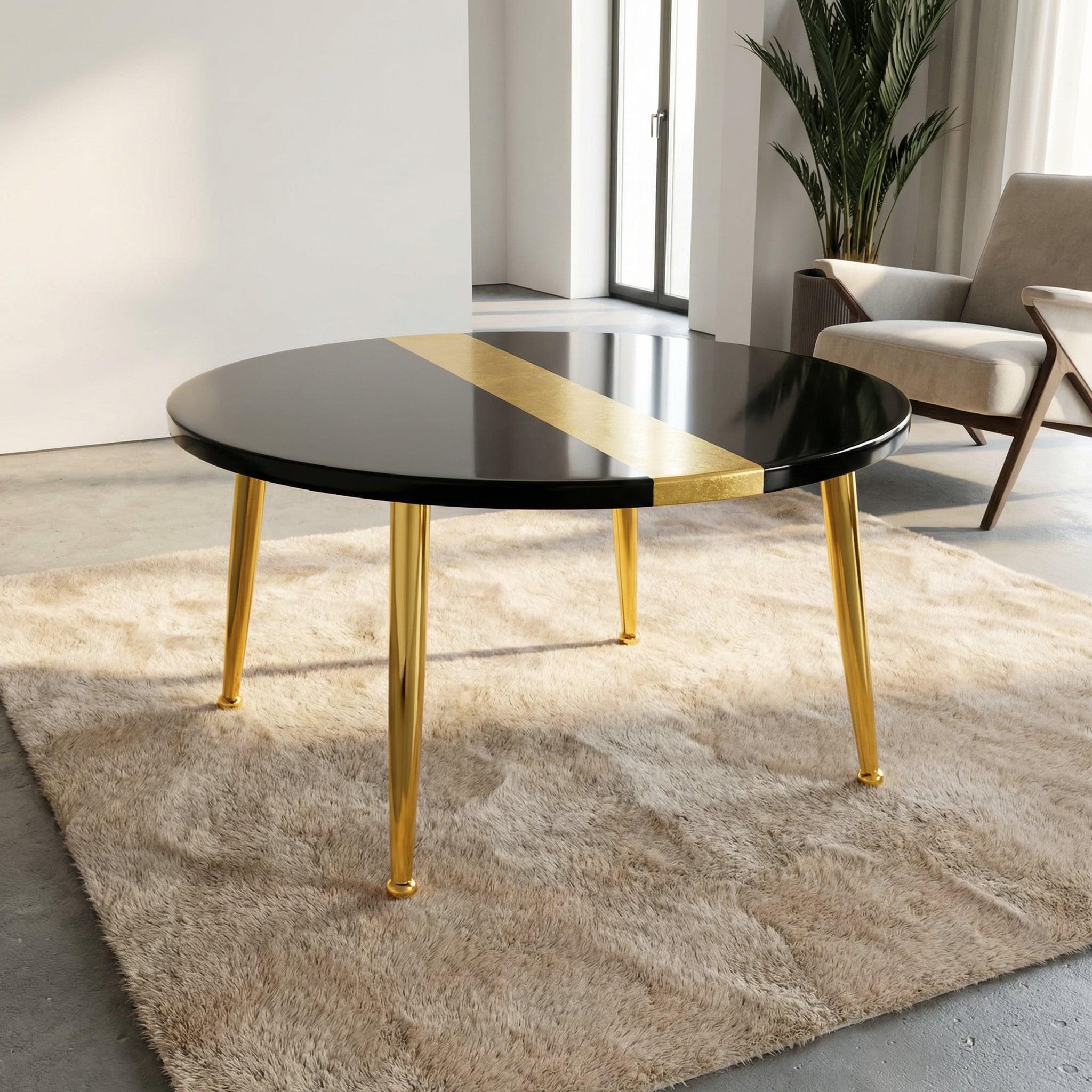 A round black coffee table with a gold stripe and gold legs. The table is set on a beige rug. The table's legs are 18 inches tall.