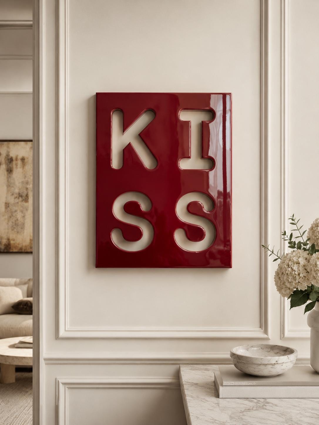A rectangular wall art piece with a glossy deep red finish featuring the word KISS cut out in a bold, block-letter font. The letters are arranged in a two-by-two grid, with K and I on the top row and S and S on the bottom row.