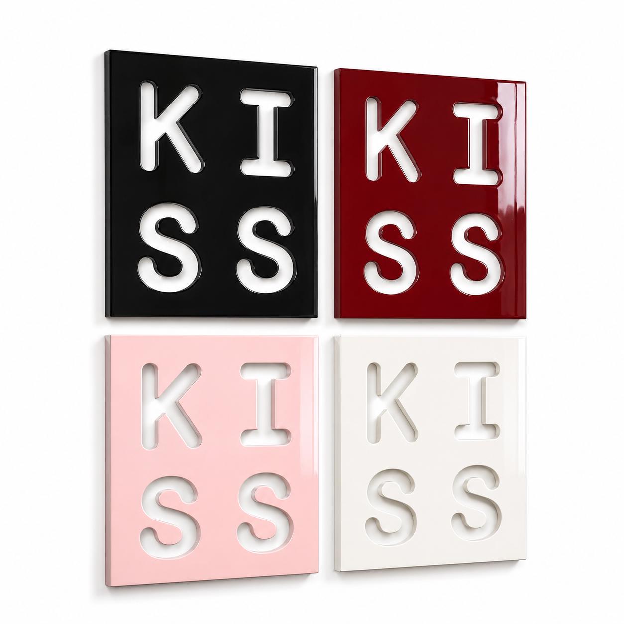 Four square wall art panels arranged in a grid. Each panel features the word KISS cut out in a bold, block font. The panels are colored black, deep red, light pink, and white, all with a smooth, glossy finish and clean edges.