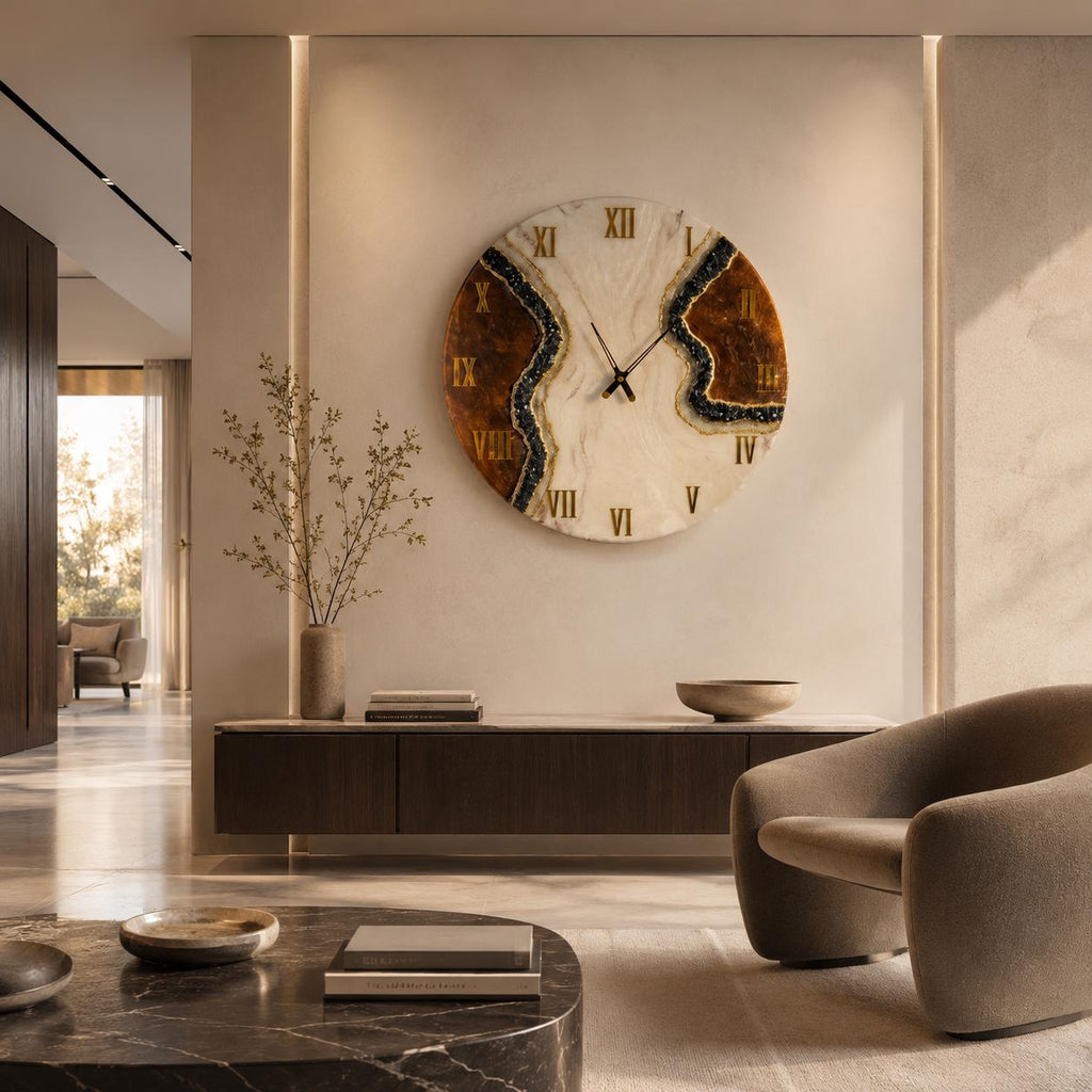 A large circular wall clock featuring a white marble-like center with a jagged, dark brown resin inlay on both sides. The clock face displays gold Roman numerals and thin black hands, creating a striking contrast against the light wall.