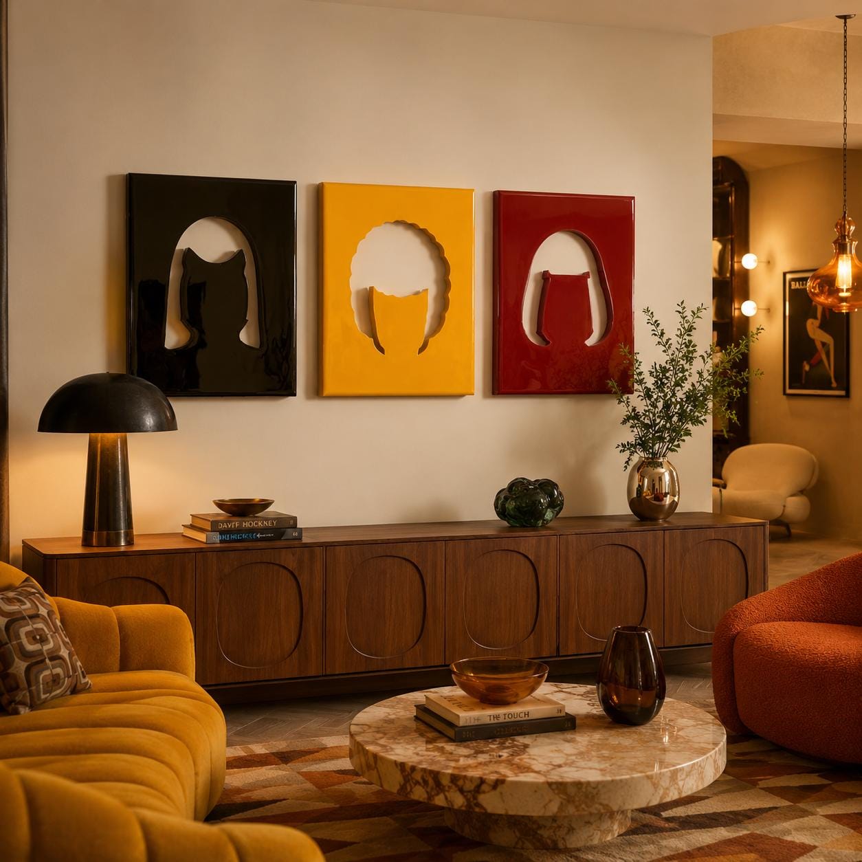 Three rectangular wall art pieces in black, yellow, and red, each featuring a central cutout silhouette of a hairstyle. These glossy panels are mounted above a long wooden sideboard with arched door details and a black table lamp.