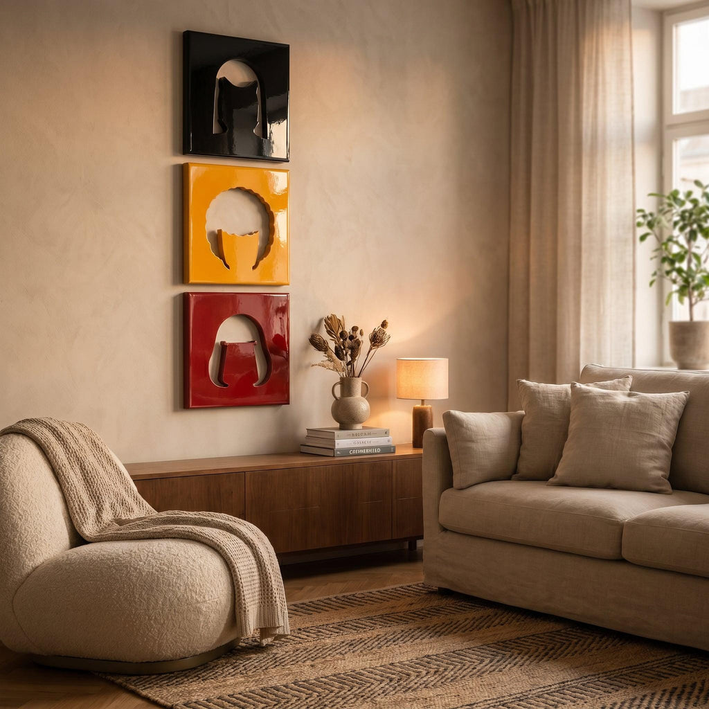 Three square wall art panels arranged vertically, each featuring a glossy finish and a central cutout silhouette of a human head. The top panel is black, the middle panel is yellow, and the bottom panel is a deep red color.