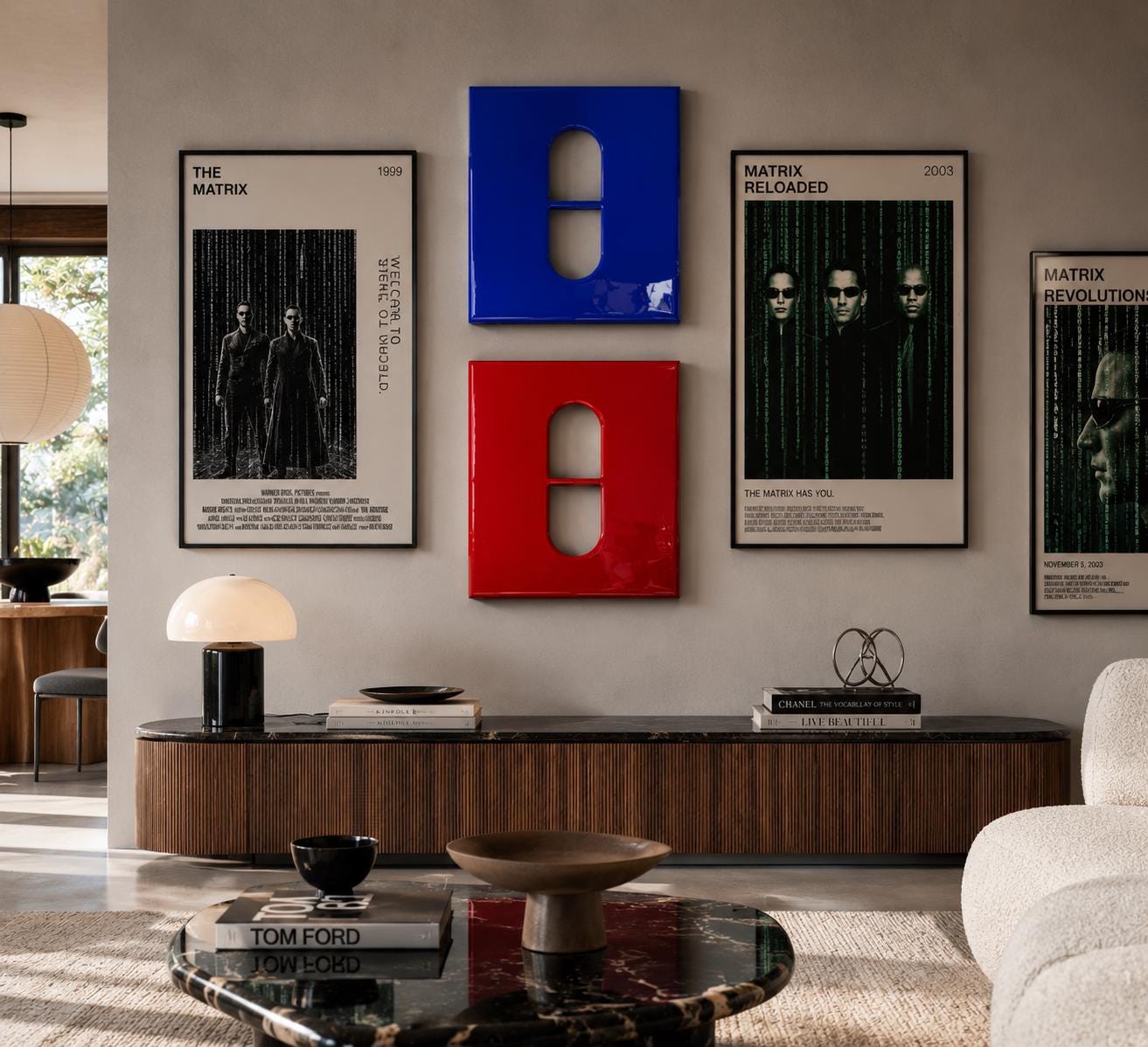 A wall display featuring two framed Matrix movie posters on the sides and two stacked square panels in the center, one blue and one red, each with a central pill-shaped cutout. The arrangement is positioned above a long wooden console.