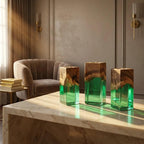 Three rectangular candle holders made from a combination of natural brown wood and translucent green resin. Each piece features a solid wood top section with a visible grain pattern and a smooth, clear green resin base.
