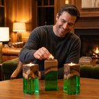 Three rectangular candle holders made of natural wood and translucent green resin. Each holder features a square wooden top with a natural grain pattern and a clear green base, designed to hold a small tea light candle on top.