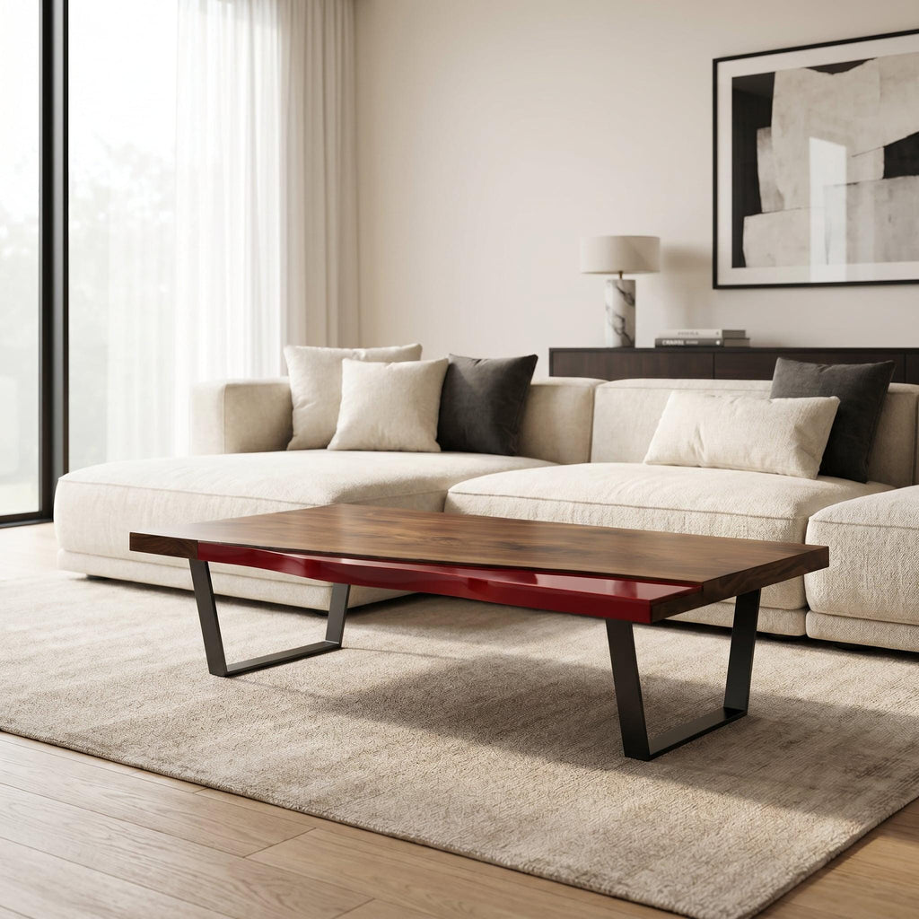 A rectangular coffee table featuring a natural wood grain top with a smooth finish, accented by a bold, glossy red resin inlay along one side. The table is supported by two black metal legs with an angular, open-frame design.