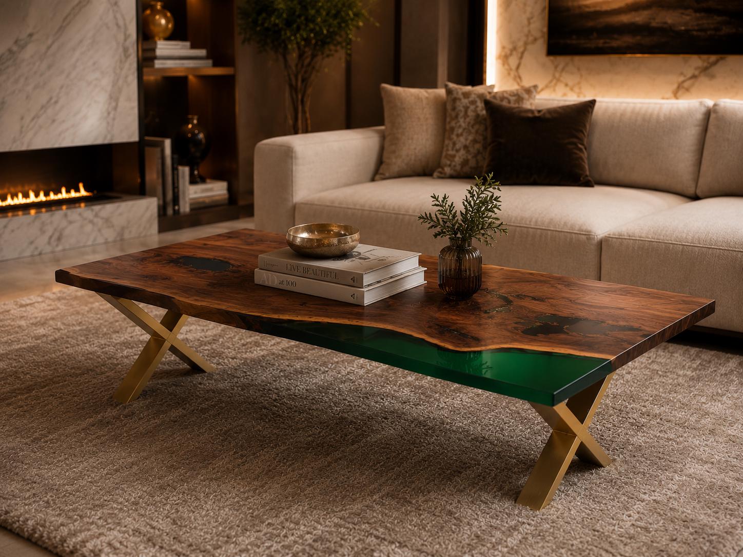 A rectangular coffee table featuring a natural live-edge dark wood slab with a vibrant green resin inlay. The tabletop is supported by a gold-colored metal base with crossed legs, creating a stable structure for this furniture piece.