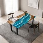 A rectangular dining table featuring a natural wood slab with a central blue resin inlay mimicking ocean waves with white foam details. The table is supported by black metal U-shaped legs and is accompanied by two wooden chairs.