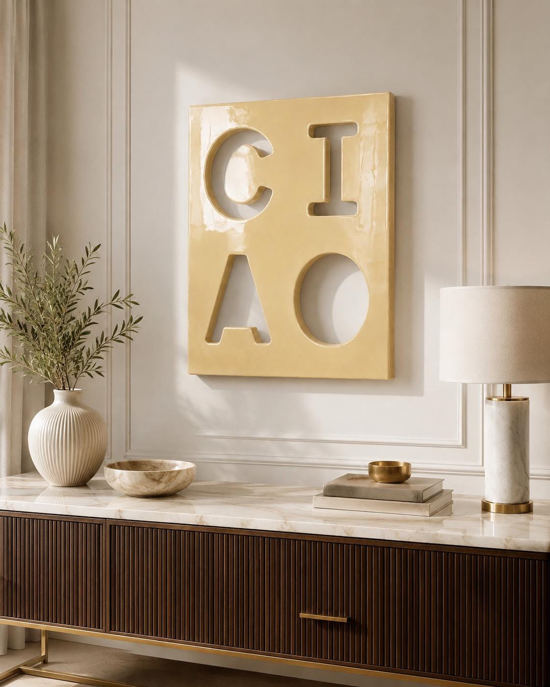 A rectangular, glossy, pale yellow wall plaque featuring the cutout letters C, I, A, and O arranged in a two-by-two grid. The surface has a smooth, reflective finish, and the letters are formed by negative space within the solid panel.