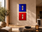 Two square wall art pieces, one blue and one red, each featuring a central vertical pill-shaped cutout. The glossy panels are mounted vertically on a neutral wall, creating a bold contrast between the primary colors and the cutout shapes.