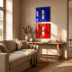 Two square wall art pieces, one glossy blue and one glossy red, each featuring a central vertical pill-shaped cutout. The blue piece is mounted directly above the red piece on a neutral wall, creating a bold, modern visual contrast.
