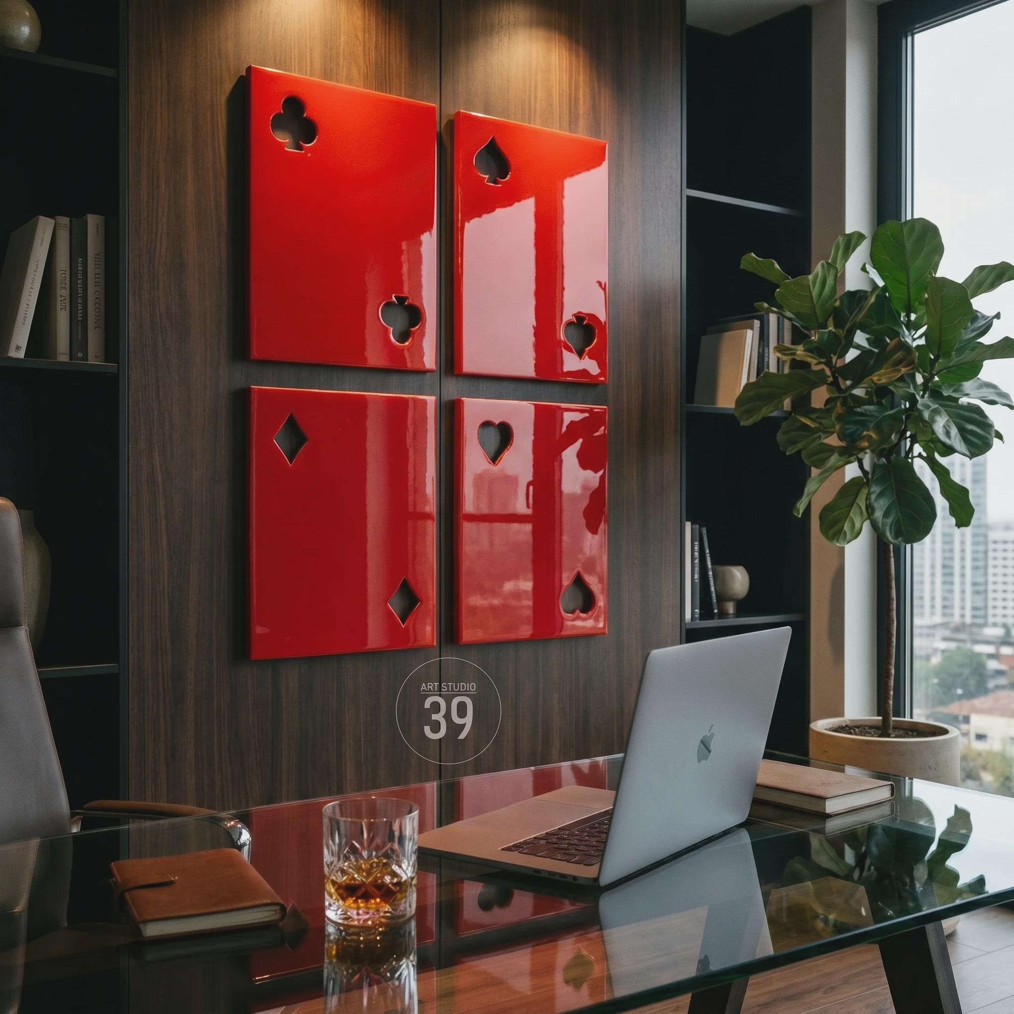 Four rectangular wall panels in a glossy red finish, each featuring a cutout of a playing card suit. The top left panel shows a club, the top right a spade, the bottom left a diamond, and the bottom right a heart. A circular logo with the text ART STUDIO 39 is visible.