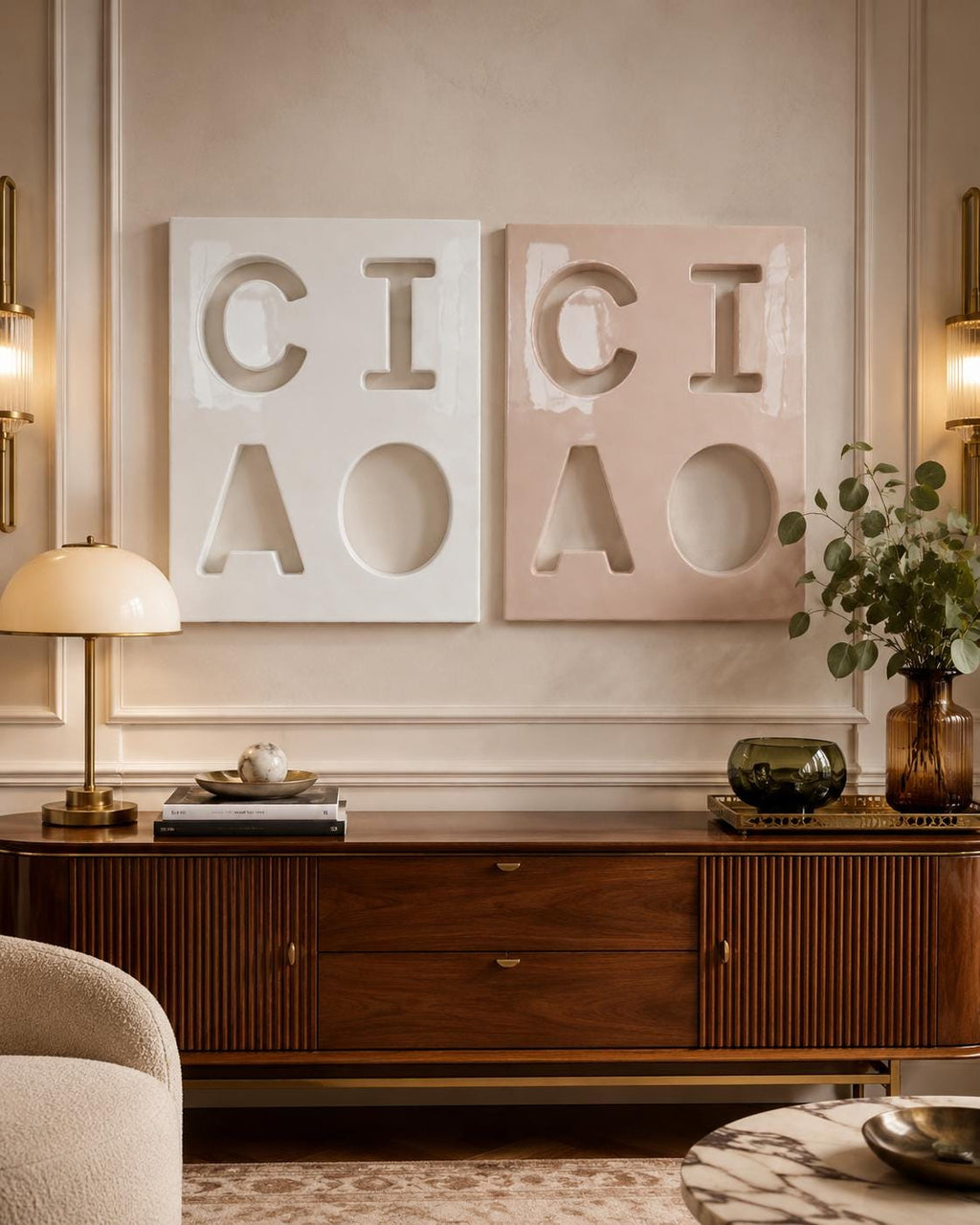 Two rectangular wall art panels featuring recessed cutouts of the letters C, I, C, and A. One panel is white and the other is a soft dusty pink. Each panel displays the letters arranged in a two-by-two grid with a smooth, matte finish.