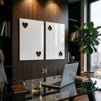 Two rectangular white wall panels mounted on a dark wood surface. The left panel features two heart-shaped cutouts, while the right panel displays two spade-shaped cutouts. A circular logo with the text ART STUDIO 39 is visible between them.