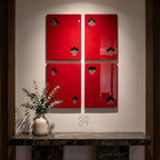 Four rectangular wall panels in a glossy red finish, each featuring a cutout representing a playing card suit. The top left panel shows a club, the top right a spade, the bottom left a diamond, and the bottom right a heart.