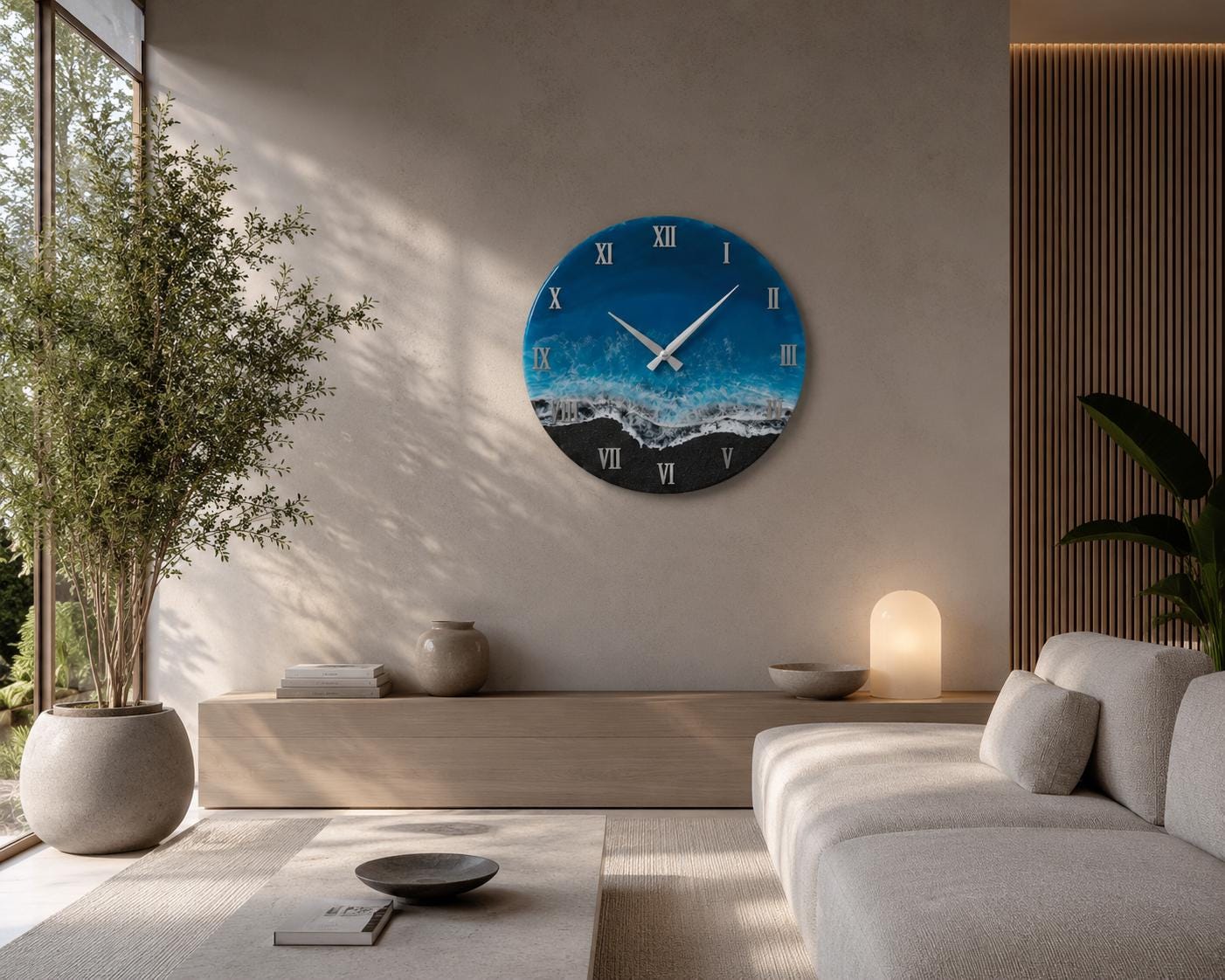 A circular wall clock featuring a resin art design that mimics an ocean shoreline. The clock face displays a deep blue sea transitioning into turquoise waves and a black sandy beach. It includes white clock hands and Roman numerals.