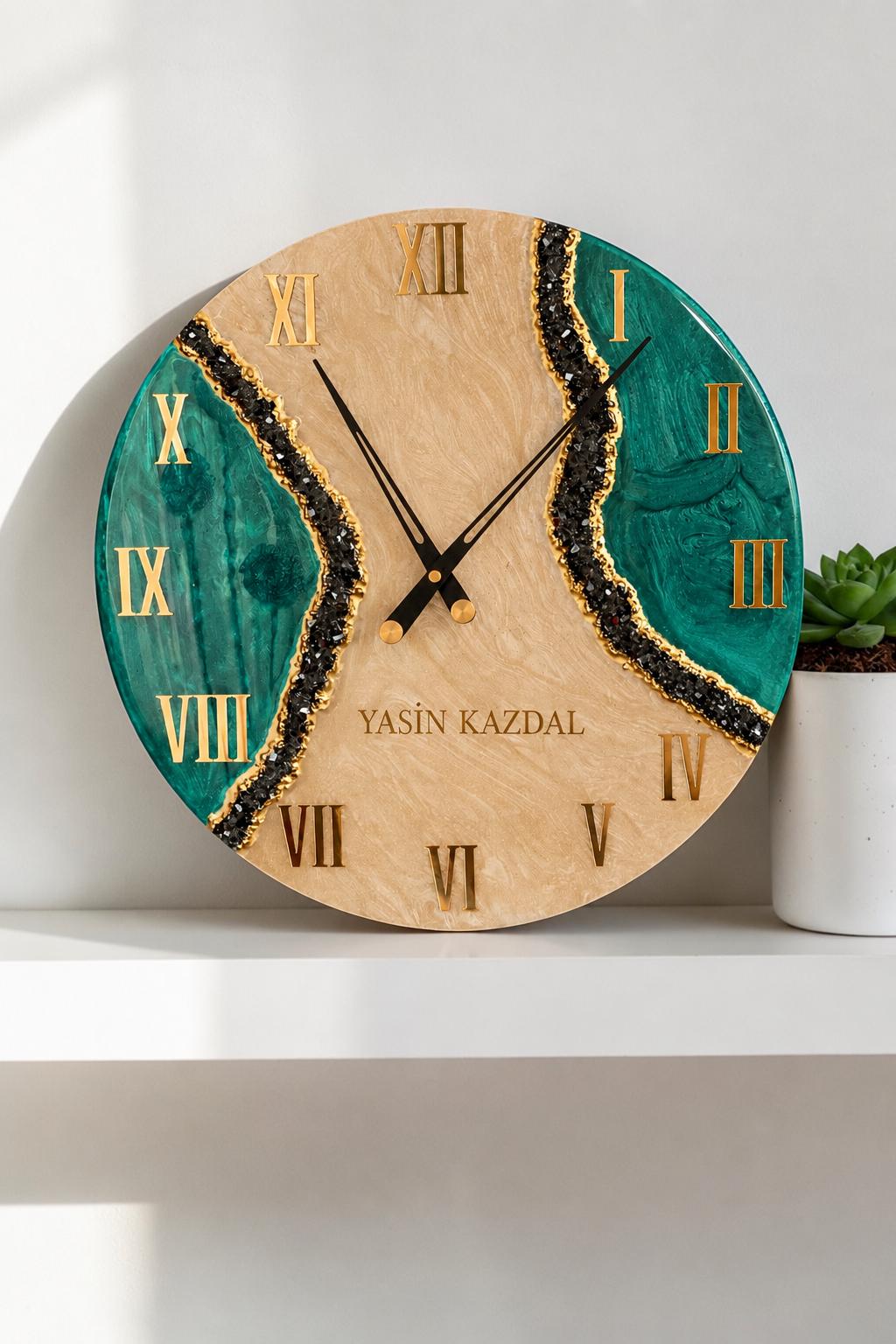 A round wall clock featuring a beige marbled center and two deep emerald green side sections separated by jagged black glitter accents. The clock face displays gold Roman numerals and the text YASIN KAZDAL with black hands.