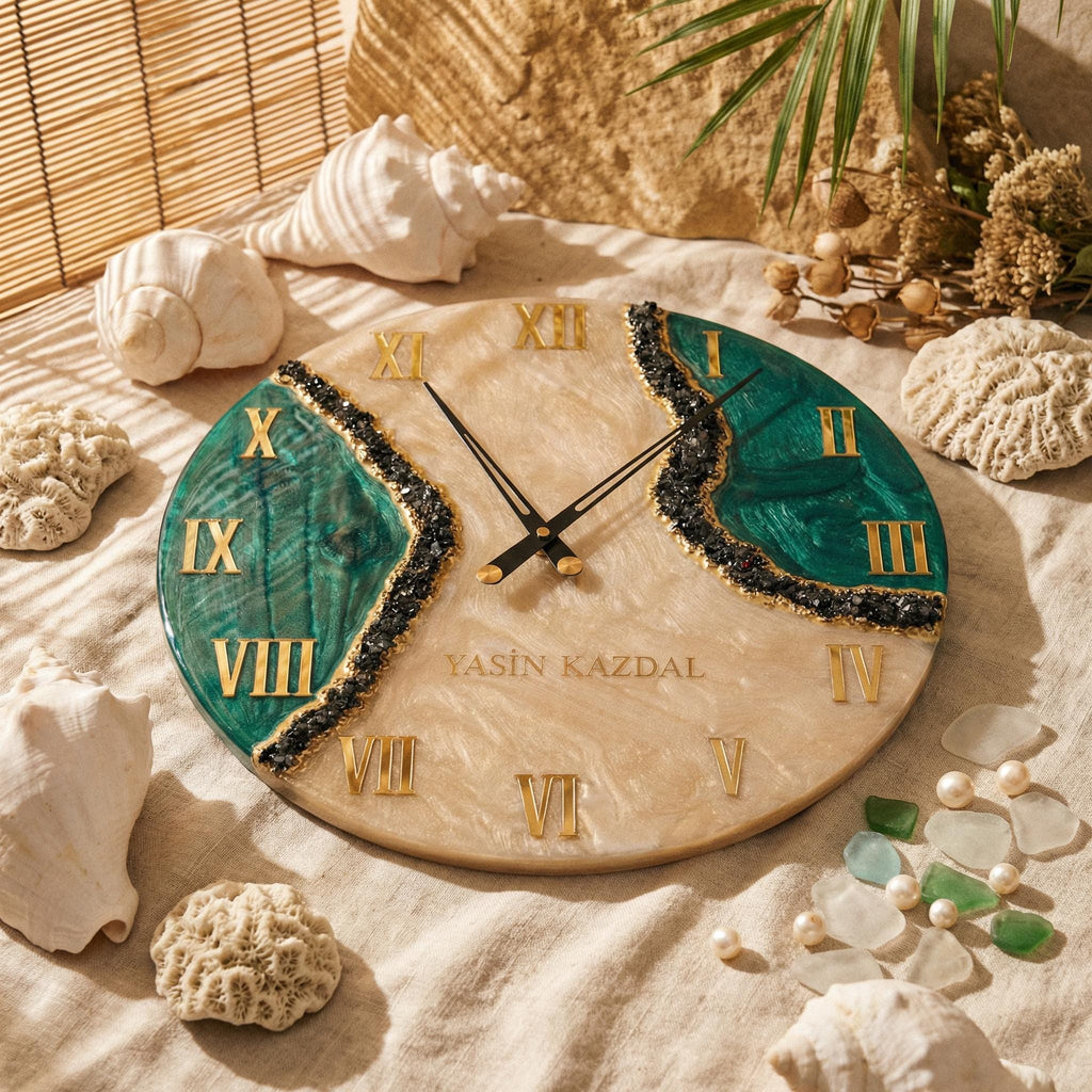 A round wall clock with a beige marbled resin base, featuring two deep green resin sections separated by black crushed stone accents. It has gold Roman numerals, black clock hands, and the text YASIN KAZDAL printed in gold.