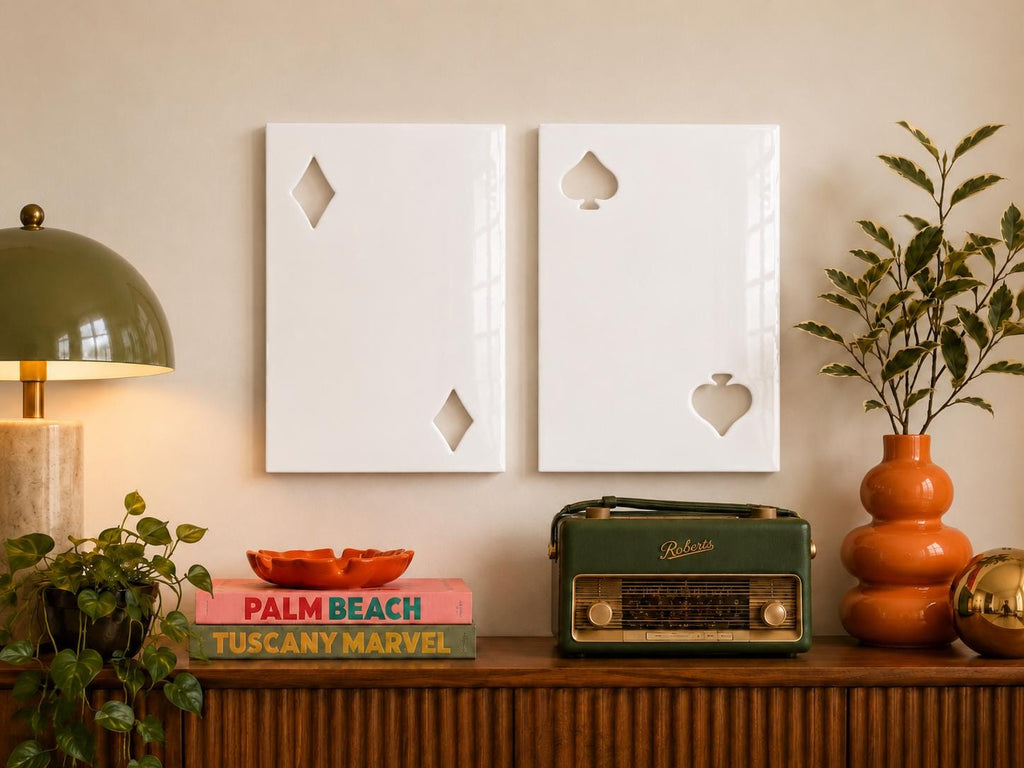 Two rectangular white wall art panels featuring cut-out shapes. The left panel displays two diamond symbols, while the right panel features two spade symbols. These glossy, minimalist wall decorations are mounted side by side.