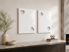 Two rectangular white wall art panels with a glossy finish. The left panel features cutouts of a heart in the top left and bottom right corners. The right panel features cutouts of a spade in the top left and bottom right corners.