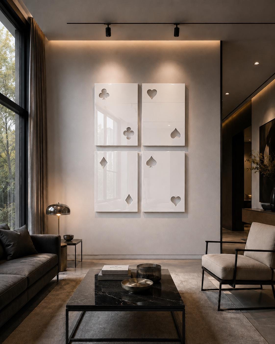 Four rectangular white wall panels arranged in a grid, each featuring cut-out shapes representing playing card suits including clubs, hearts, diamonds, and spades. The glossy panels are mounted on a smooth, neutral-toned wall surface.